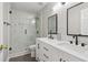 Modern bathroom with white double sink vanity, a glass shower, and black hardware at 112 Rotherhithe Nw Ln, Marietta, GA 30066