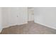 Cozy bedroom with neutral carpeting and a view to another room through an open door at 112 Rotherhithe Nw Ln, Marietta, GA 30066