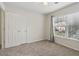 Comfortable bedroom with natural light, neutral walls and carpet and a double door closet at 112 Rotherhithe Nw Ln, Marietta, GA 30066