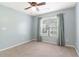 Charming bedroom features light blue walls, a ceiling fan, and a window with natural light at 112 Rotherhithe Nw Ln, Marietta, GA 30066