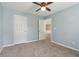 Light blue bedroom featuring a ceiling fan, carpet, and a closet at 112 Rotherhithe Nw Ln, Marietta, GA 30066
