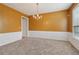 Classic dining room boasts wainscoting, chandelier, and a bright window at 112 Rotherhithe Nw Ln, Marietta, GA 30066