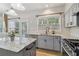 Bright kitchen features granite counters, stainless appliances, and an island perfect for entertaining at 112 Rotherhithe Nw Ln, Marietta, GA 30066