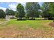 Expansive green lawn for recreational activities, framed with a soccer goal for sports and fun, and houses in the background at 112 Rotherhithe Nw Ln, Marietta, GA 30066