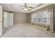 Spacious main bedroom with tray ceiling, ceiling fan, and large window offering plenty of natural light at 112 Rotherhithe Nw Ln, Marietta, GA 30066