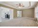 Spacious main bedroom features neutral carpet, a ceiling fan, and access to an ensuite bathroom at 112 Rotherhithe Nw Ln, Marietta, GA 30066
