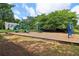 Well-equipped community playground featuring slides, climbing structures, and swings, with a home in the background at 112 Rotherhithe Nw Ln, Marietta, GA 30066