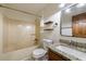 Bathroom featuring a shower-tub combo, granite countertop vanity, framed mirror, and two floating wood shelves at 335 Whisper Way, Dacula, GA 30019