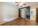 Bright bedroom features wood-look flooring, a ceiling fan, a closet with sliding doors, and neutral paint at 335 Whisper Way, Dacula, GA 30019