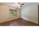 Comfortable bedroom with wood floors, ceiling fan, and natural light at 335 Whisper Way, Dacula, GA 30019