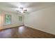 Serene bedroom featuring hardwood floors and large windows at 335 Whisper Way, Dacula, GA 30019