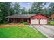 Charming single-story home with a covered porch, landscape beds, a long driveway, and a two-car garage at 335 Whisper Way, Dacula, GA 30019