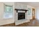Cozy fireplace with a stone surround, mantle, and a window view at 335 Whisper Way, Dacula, GA 30019