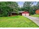 Charming single-story home with a two-car garage, a well-manicured lawn, and mature trees at 335 Whisper Way, Dacula, GA 30019