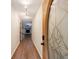 Hallway showcasing wood floors and a decorative front door leading into the living space with a fireplace at 335 Whisper Way, Dacula, GA 30019