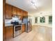 Well-lit kitchen with stainless steel appliances and wood cabinets at 335 Whisper Way, Dacula, GA 30019