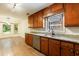Bright kitchen featuring wooden cabinets, granite countertops, and stainless steel appliances at 335 Whisper Way, Dacula, GA 30019