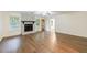 Spacious living room with wood floors, a fireplace, and natural light from the windows at 335 Whisper Way, Dacula, GA 30019
