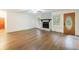 Open living room with wood floors, a fireplace, and access to the front door at 335 Whisper Way, Dacula, GA 30019
