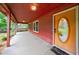 Inviting covered porch with wood floors and a charming front door with a decorative window at 335 Whisper Way, Dacula, GA 30019