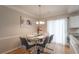 Elegant dining room with modern table, chandelier, and hardwood floors at 3497 Mount Vernon Cir, Atlanta, GA 30340