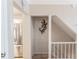 Hallway with view of stainless steel refrigerator and white staircase with white bannister at 3497 Mount Vernon Cir, Atlanta, GA 30340