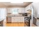 Well-equipped kitchen with stainless appliances, granite counters, and hardwood floors at 3497 Mount Vernon Cir, Atlanta, GA 30340