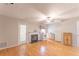 Bright living space with fireplace, wood floors, ceiling fan, and an adjacent kitchen offering convenience at 3497 Mount Vernon Cir, Atlanta, GA 30340