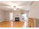 Open-concept living room with fireplace, wood floors, ceiling fan and access to the kitchen and patio at 3497 Mount Vernon Cir, Atlanta, GA 30340
