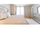 Bright main bedroom with wood floors, stylish dresser and a plush rug that adds a layer of coziness at 3497 Mount Vernon Cir, Atlanta, GA 30340