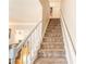Carpeted staircase with white railing leading to upper level, complemented by hardwood floors in the adjacent room at 3497 Mount Vernon Cir, Atlanta, GA 30340