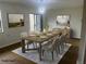 The virtually staged dining room is well-lit, showcasing modern decor and wood floors at 475 Mount Vernon Ne Hwy # C230, Sandy Springs, GA 30328