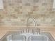 Kitchen sink features tile backsplash, stainless-steel sink, and modern fixtures at 475 Mount Vernon Ne Hwy # C230, Sandy Springs, GA 30328