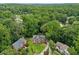 Aerial view of a beautiful home with a well-manicured lawn surrounded by mature trees and landscaping at 992 Marbury Sw Ct, Marietta, GA 30064