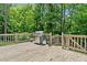 The large, wood back deck features a stainless steel grill and a lovely wooded view at 992 Marbury Sw Ct, Marietta, GA 30064
