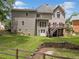 Expansive backyard featuring a lush lawn, mature trees, multi-level deck and patio area, offering privacy at 992 Marbury Sw Ct, Marietta, GA 30064
