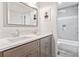Updated bathroom featuring double sinks, gray tiled floors, and shower over tub at 992 Marbury Sw Ct, Marietta, GA 30064