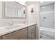 Gray-toned bathroom showcasing double sinks, framed mirrors and a shower/tub combination at 992 Marbury Sw Ct, Marietta, GA 30064