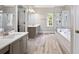 Open concept bathroom with dual sink vanities, a separate shower, and a soaking tub at 992 Marbury Sw Ct, Marietta, GA 30064