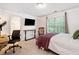 Bedroom featuring a desk, chair, tv, and a queen sized bed with a purple throw blanket at 992 Marbury Sw Ct, Marietta, GA 30064