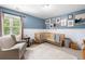 Light blue Bedroom with two baby cribs, a cozy armchair, and decor art on the wall at 992 Marbury Sw Ct, Marietta, GA 30064