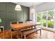 Dining room with a large window, modern lighting, and a long wooden table with seating at 992 Marbury Sw Ct, Marietta, GA 30064