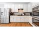 Modern kitchen has white cabinets, stainless appliances, and granite countertops at 992 Marbury Sw Ct, Marietta, GA 30064
