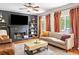 Cozy living room with fireplace, TV, tan sofa, and warm, inviting colors at 992 Marbury Sw Ct, Marietta, GA 30064