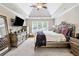 Spacious main bedroom with tray ceilings, plush bedding, and a decorative mirror at 992 Marbury Sw Ct, Marietta, GA 30064
