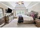 Spacious main bedroom with tray ceilings, TV, dresser, and a serene ambiance at 992 Marbury Sw Ct, Marietta, GA 30064