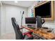 Office space including a computer desk, TV, and a black and red gaming chair at 992 Marbury Sw Ct, Marietta, GA 30064