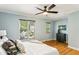 Bright bedroom featuring multiple windows, light blue walls, and hardwood flooring at 1002 Defoors Nw Lndg, Atlanta, GA 30318