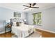 Cozy bedroom featuring a ceiling fan, natural light from the window, and a neutral color palette at 1002 Defoors Nw Lndg, Atlanta, GA 30318