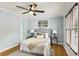 Comfortable bedroom featuring hardwood floors, modern decor, and a large window with natural light at 1002 Defoors Nw Lndg, Atlanta, GA 30318